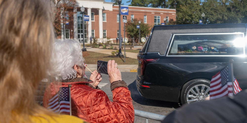 The casket carrying former first lady Rosalynn Carter makes its way through Georgia Southwestern State University in Americus on Nov. 27, 2023.