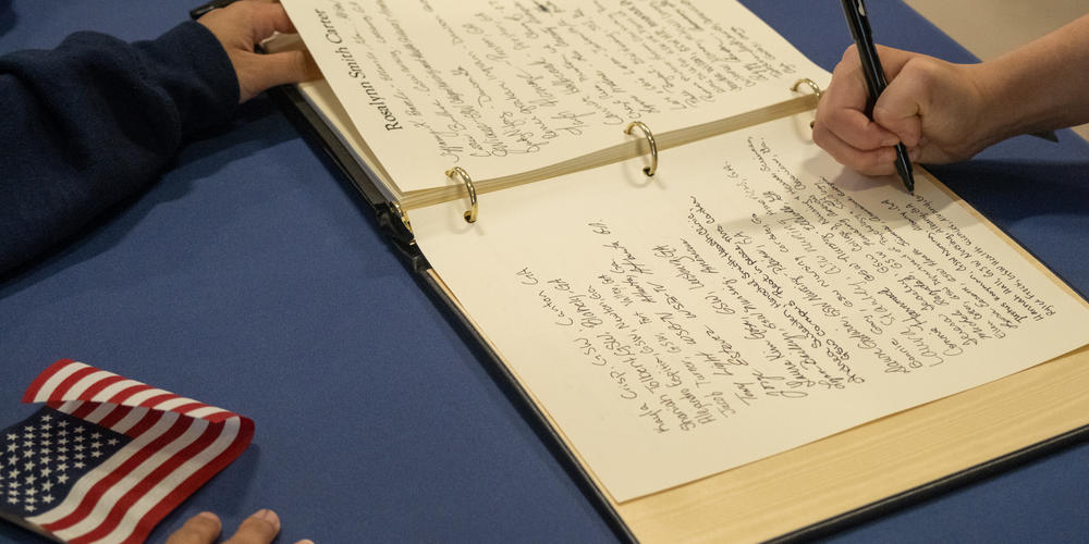 People sign a book of condolences at the Rosalynn Carter Health and Human Sciences Complex at Georgia Southwestern State University.