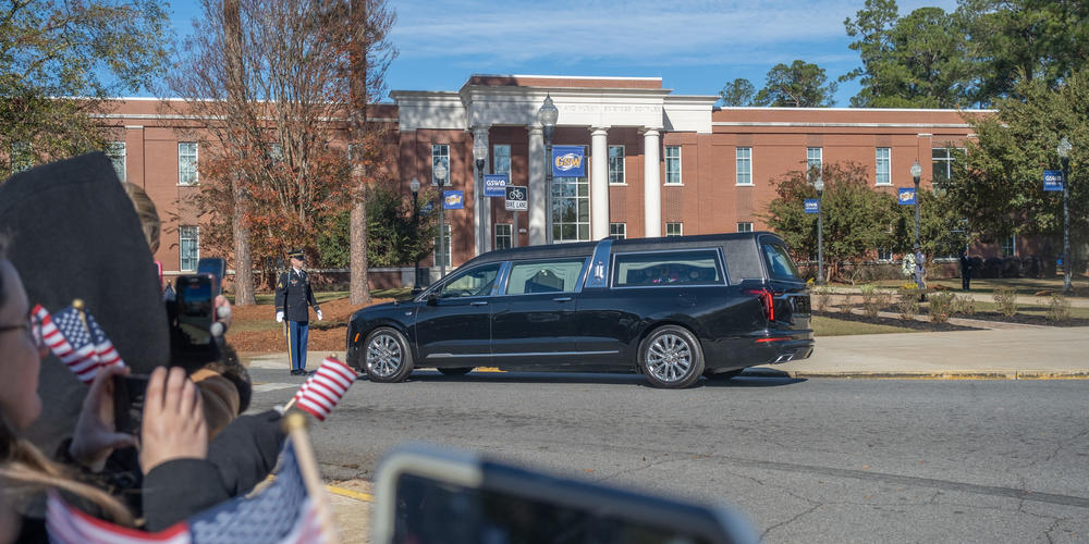 A motorcade for former first lady Rosalynn Carter makes its way through Georgia Southwestern State University in Americus on Nov. 27, 2023.