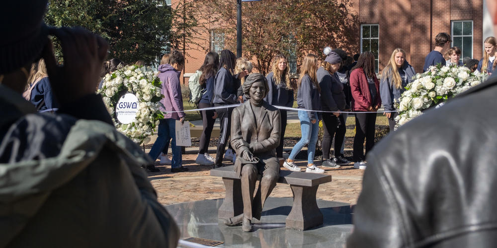 Visitors surround a bronze statue of former First Lady Rosalynn Carter at Georgia Southwestern State University on Nov. 27.