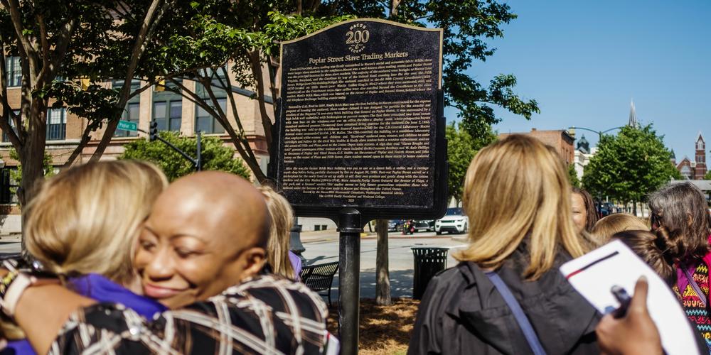 A new historical marker on Macon's Poplar Street describes the slave market on the site of the brick building in the left background of the image which at one time recently was a yoga studio. 