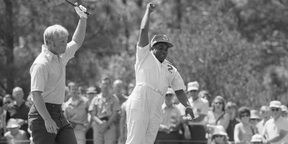 Jack Nicklaus throws up his putter as his caddy, Willie Peterson leaps into the air after his putt sank for a birdie on the first hole at Augusta, Ga., April 11, 1971, during the Masters Golf Tournament. With this putt Nicklaus took the lead of the final round with 8-under-par. (AP Photo/Perry Aycock)
