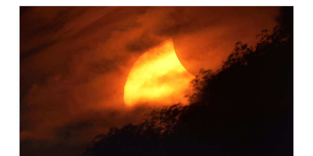 A partial eclipse at sunset, October 23, 2014. CreditPhilip Groce.