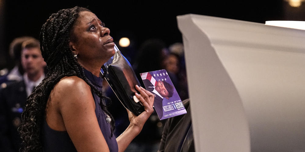 A mourner stands at the casket of slain airman Roger Fortson during his funeral at New Birth Missionary Baptist Church, Friday, May 17, 2024, near Atlanta.