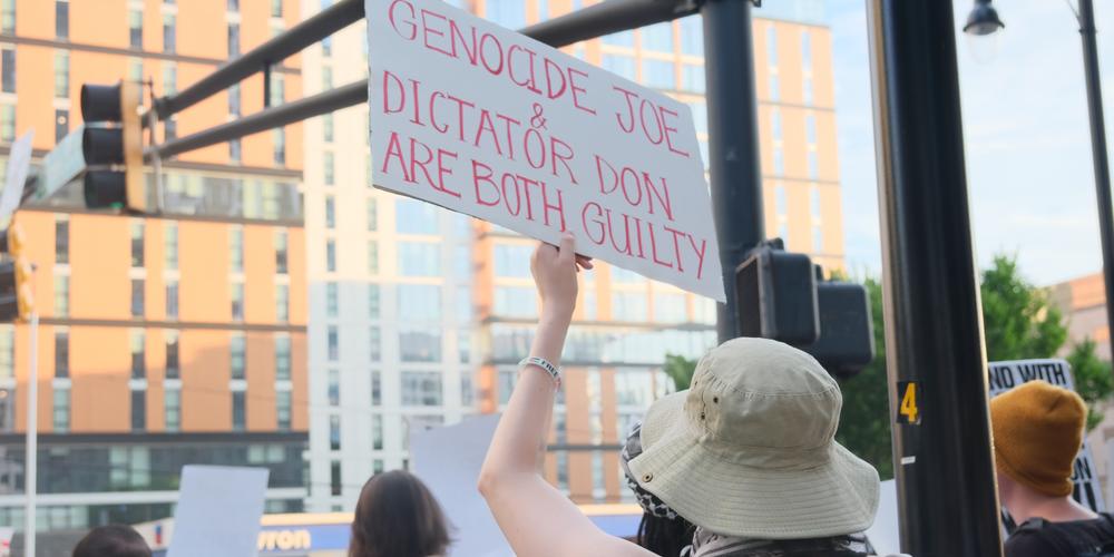 A protester holds signage in Midtown Atlanta on June 27, 2024.