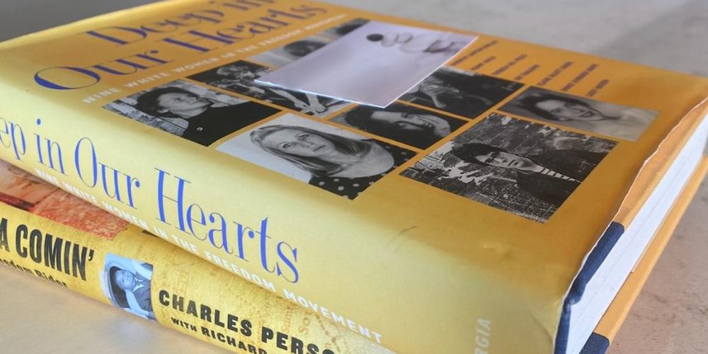 Copy of the book "Deep in Our Hearts" sits atop a copy of Charles Person's memoir "Buses Are a Comin': Memoir of a Freedom Rider."