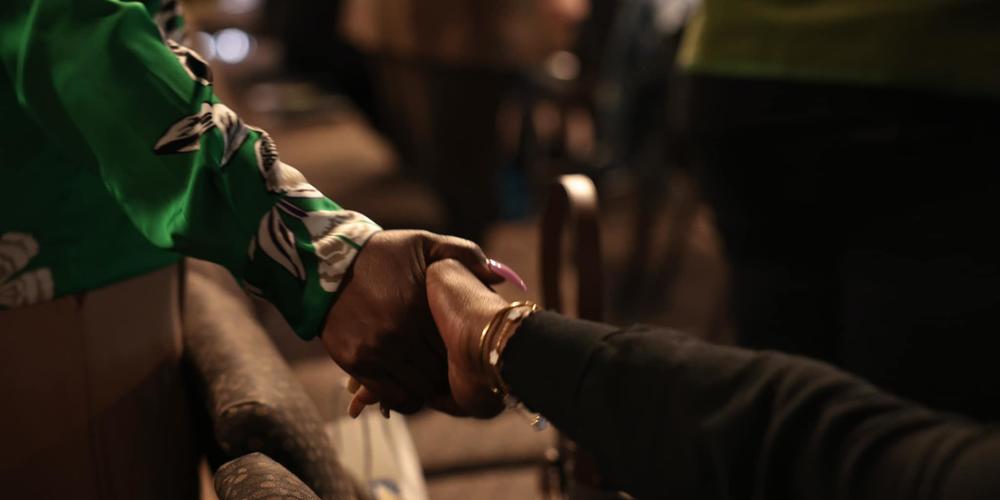 Congregants join hands during church service at Destiny Christian Center International.