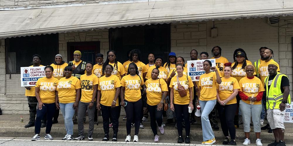 Organizers from Atlanta and Augusta pose for a group picture before canvassing in Augusta to register voters.