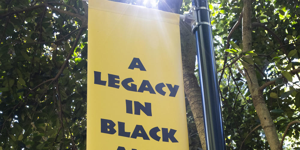 A sign reads, "A Legacy in Black and White."