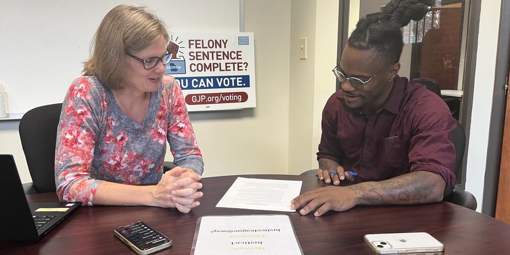 Ann Colloton and Dominique Harris work on outreach to spread the word that people who have a felony conviction in their past may be eligible to vote. 