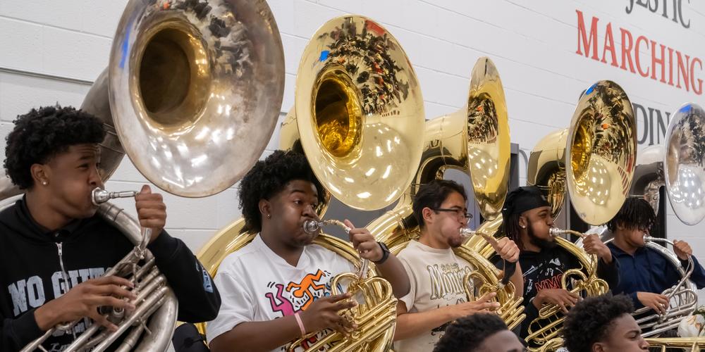 The Jonesboro High Majestic Marching Cardinals play their instruments during their final band practice before heading off to the Macy's Thanksgiving Day Parade.