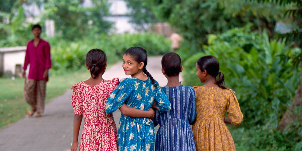 Barefoot girls in dresses walking. Photography by Billy Howard