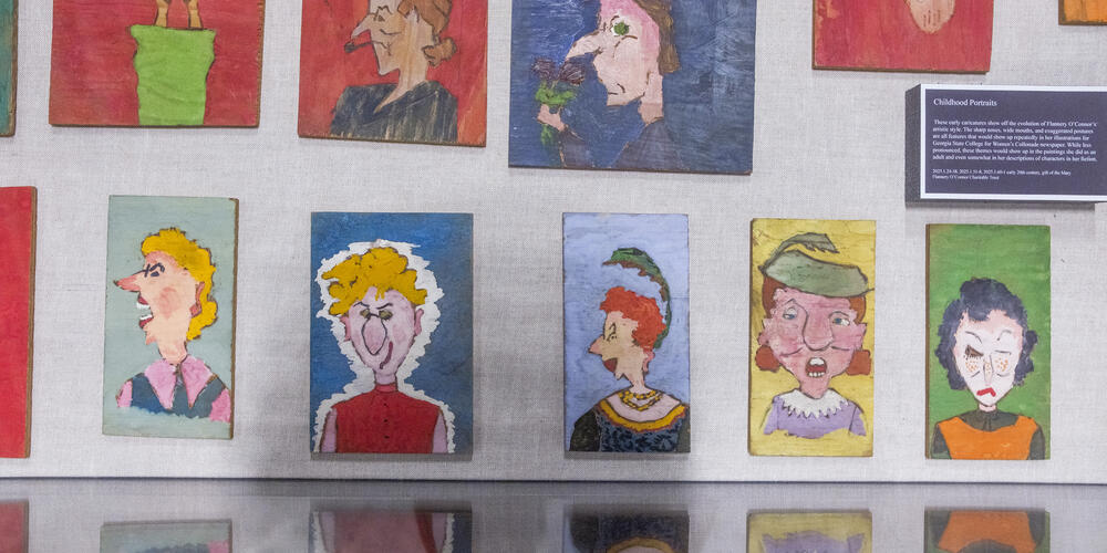 Flannery O’Connor drew and painted these faces on little pieces of wood when she was a child.