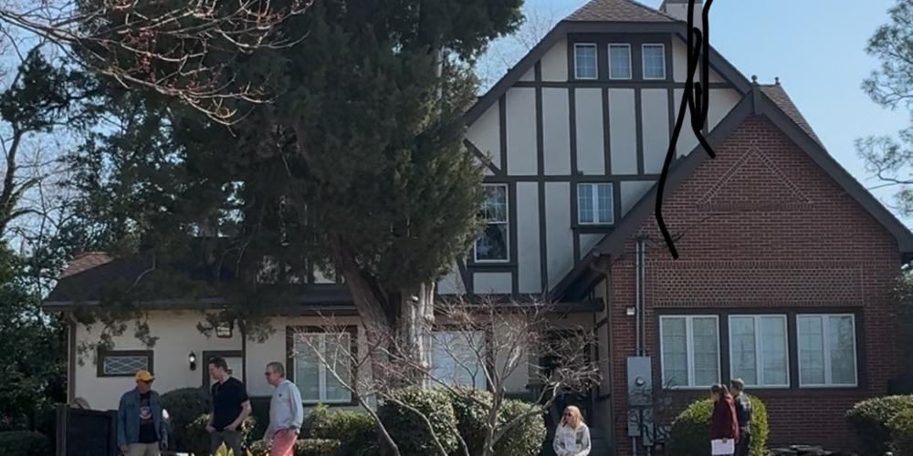 Fans are show in the front yard of "The Big House" at the corner of Vineville Avenue and Highway 41 in Macon, Ga., on March 1, 2025.  The dwelling housed the Allman Brothers Band in their early days and now serves as a museum of the band's career.