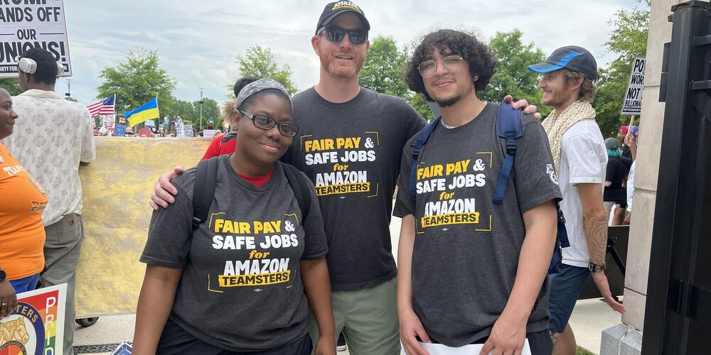 three amazon workers wear shirts saying fair pay and safe jobs for amazon teamsters