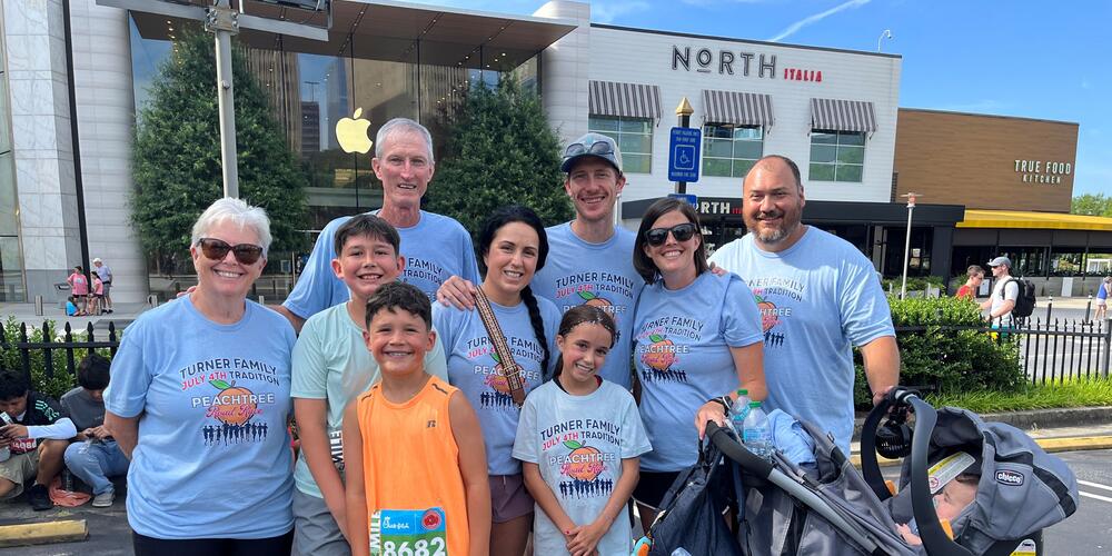 The Turner Family wearing blue custom shirts for the Peachtree Road Race