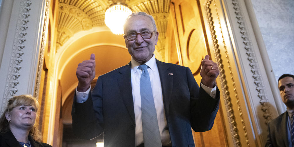 Senate Majority Leader Chuck Schumer gives the thumbs up as he leaves the Senate Chamber after passage of the Inflation Reduction Act on Sunday.