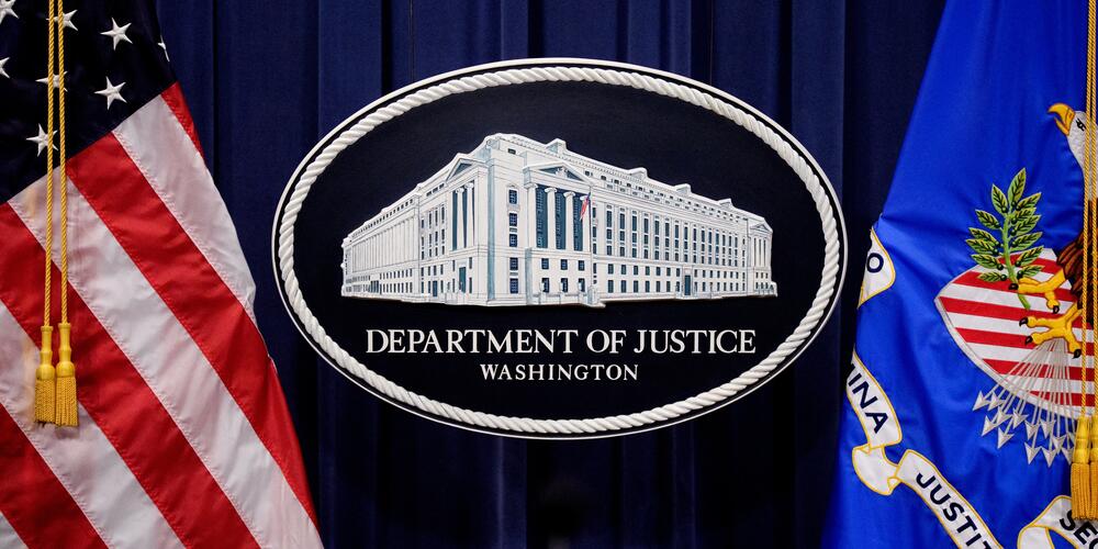 The Department of Justice logo is displayed before U.S. Attorney General Pam Bondi arrives for a news conference at the agency on May 6 in Washington, D.C. The department announced in a June memo that it is aggressively prioritizing efforts to strip some Americans of their U.S. citizenship.