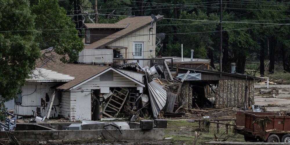A home covered in debris sits near the town center on July 6, 2025, in Hunt, Texas. Heavy rainfall caused flooding along the Guadalupe River in central Texas, with multiple fatalities reported.