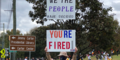 Women holds up you're fired sign