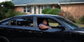 Ahmaud Arbery’s Aunt, Theawanza Brooks, rides in a car down Satilla Drive, the street where her nephew took his last breath, during a car procession in Brunswick on Oct. 16.