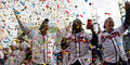 Braves players Dansby Swanson, Touki Tousaaint and Joc Pederson cheer under a shower of confetti during the team’s celebration at Trusit Park on Nov. 5.