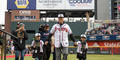 Atlanta Braves manager Brian Snitker walks onto Truist Park field with his family during the World Series victory celebration on Nov. 5.