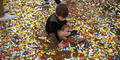 A young Braves fan plays in the fallen confetti during the team’s World Series victory celebration at Truist Park on Nov. 5.