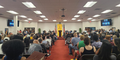 Atlanta SAG-AFTRA members and supporters fill the main room of the International Alliance of Theatrical Stage Employees Local 479 union headquarters during a rally July 17, 2023. All seats are filled, with people standing against the wall. A SAG-AFTRA banner hangs on the far wall.