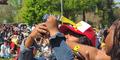 Ryan Washington uses the Fernbank Science Center eclipse viewers to take a picture of the sun on her phone in Atlanta, Ga., on April 8, 2024.