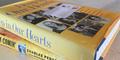 Copy of the book "Deep in Our Hearts" sits atop a copy of Charles Person's memoir "Buses Are a Comin': Memoir of a Freedom Rider."