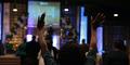 A woman raises her hands during church at Destiny Christian Center International.