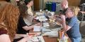 On Oct. 6, 2024, students and faculty participate in a collage and zine-making exercise utilizing the dust jackets of books donated by Sir Elton John. 
