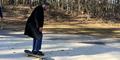 Atlanta City Councilman Antonio Lewis gets on a skateboard after the official ribbon cutting on Ruby Harper Skatepark.