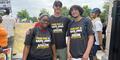 three amazon workers wear shirts saying fair pay and safe jobs for amazon teamsters