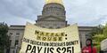 A gold banner says "Waffle House: Our dedication deserves dignity pay us $25!"