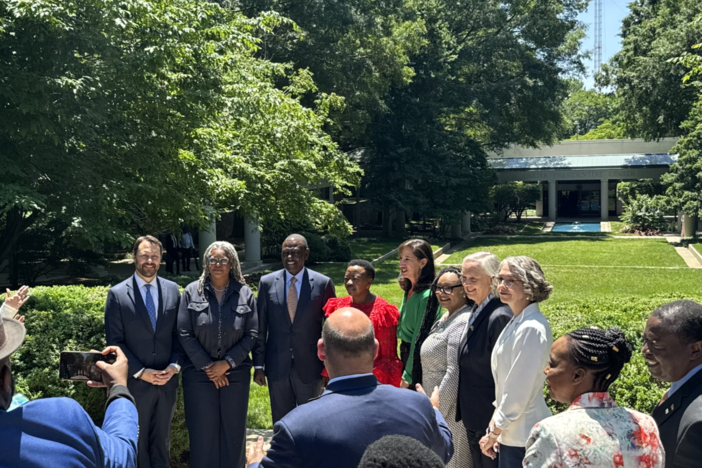 Kenya's President William Ruto (third from left) and his wife Rachel Ruto (in red) are flanked by Carter Center executives and U.S. Ambassador to Kenya (second from right) Meg Whitman outside the Jimmy Carter Library and Museum during the African leader's visit to Atlanta on May 20, 2024.