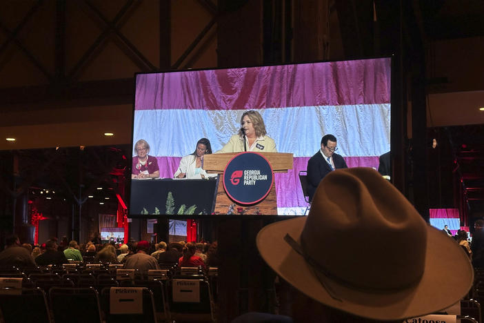 An attendee watches as Amy Kremer asks delegates to elect her to the Republican National Committee, Saturday, May 18, 2024, at the Georgia Republican Party State Convention in Columbus, Ga. Delegates voted for Kremer, who helped organize the pro-Donald Trump rally, Jan. 6, 2021, that led to a mob storming the U.S. Capitol.