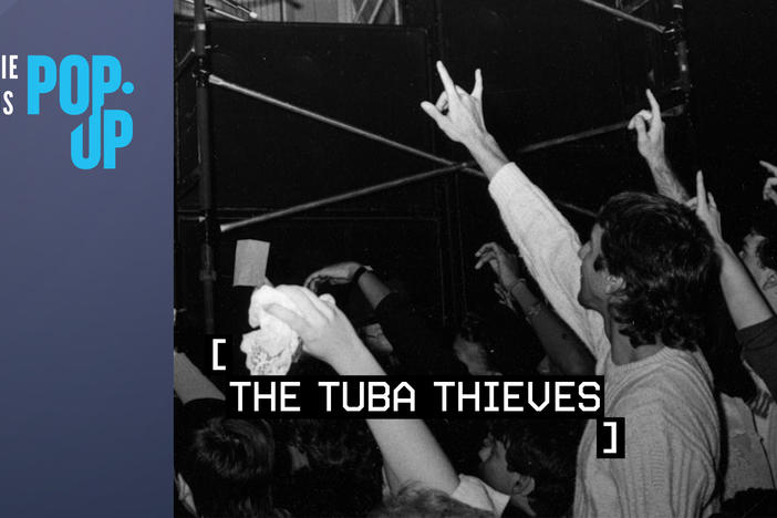 Film title: [The Tuba Thieves] and Indie Lens Pop-Up logo over a black and white photo of people raising their hands at a concert. 